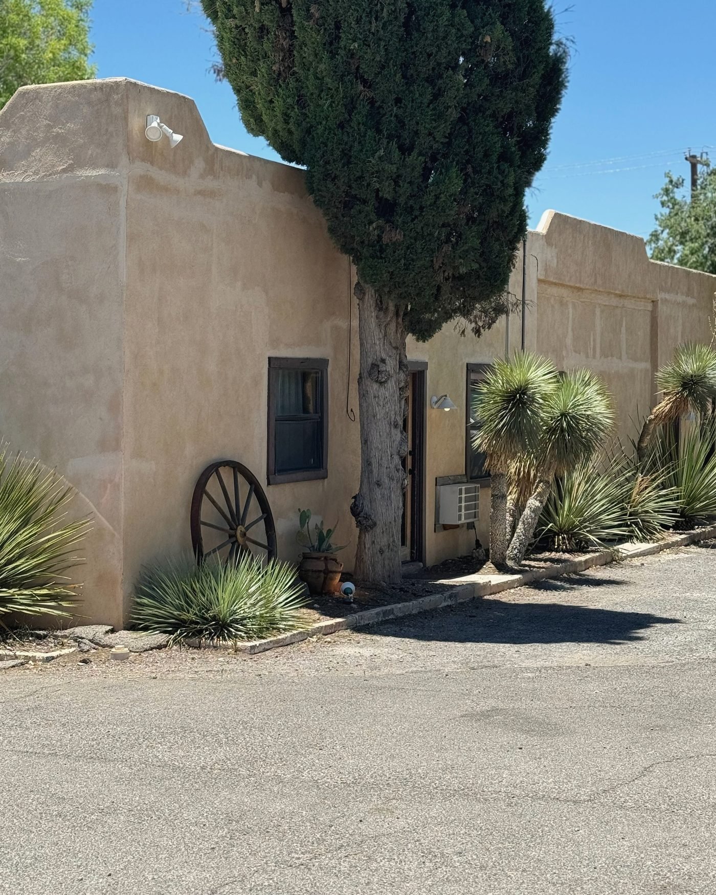 Adobe-style casita with yuccas and desert plantings